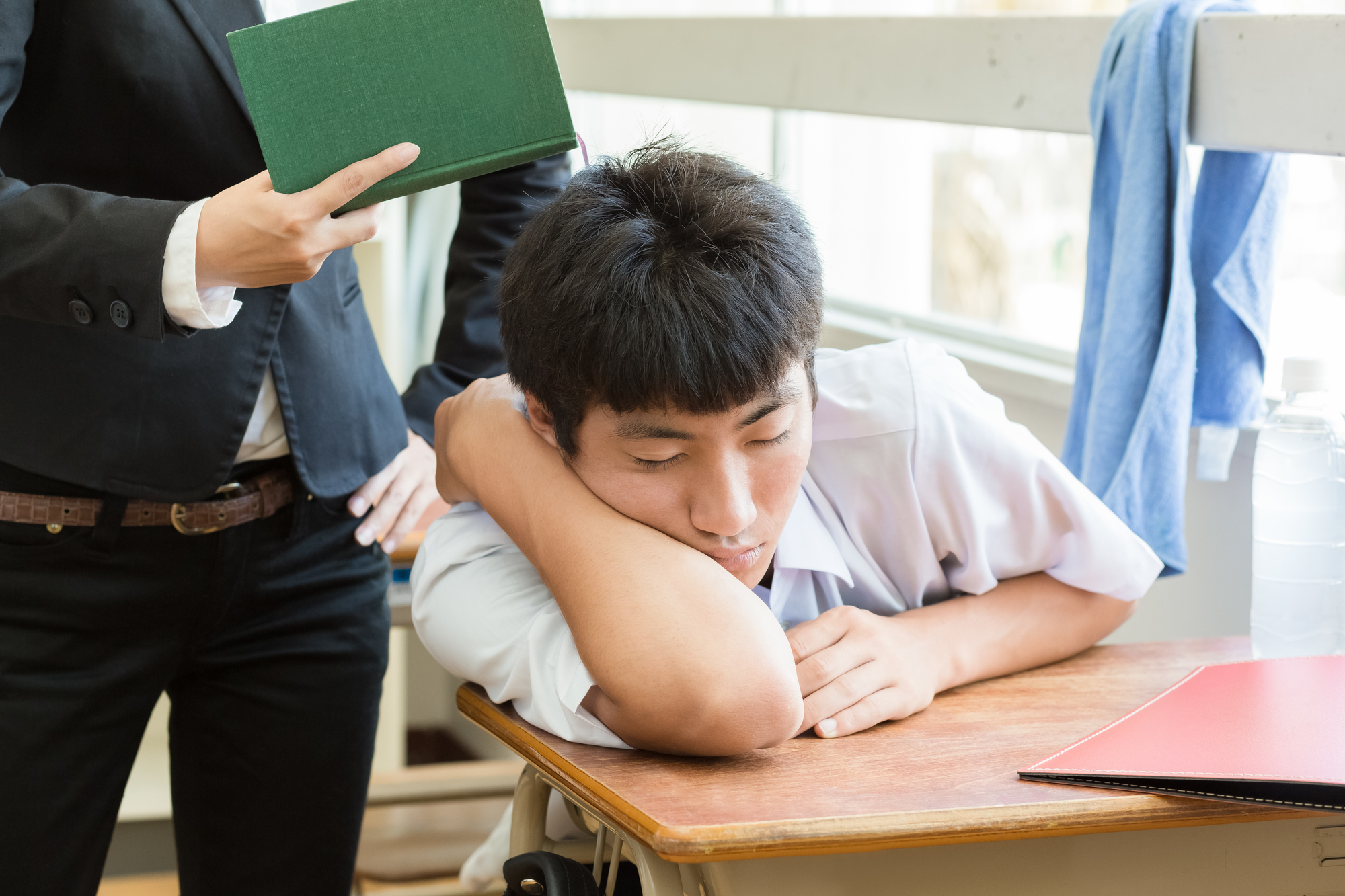 授業中に居眠りをする男子高生